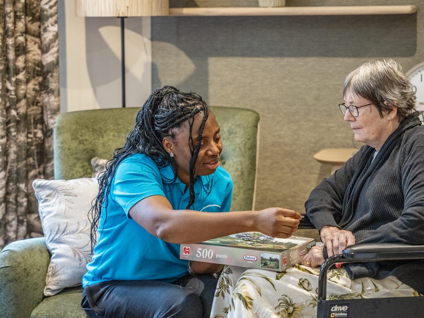 A carer and a resident doing a jigsaw at Cedar Lodge