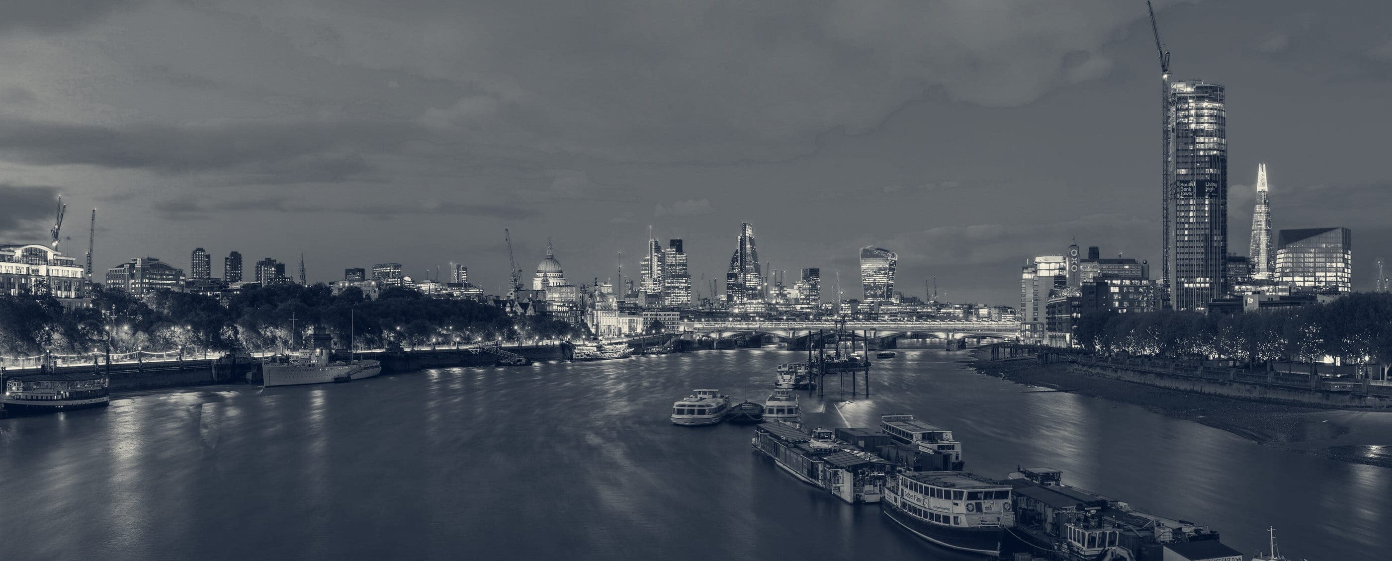 The City of London skyline at dusk, seen across the Thames